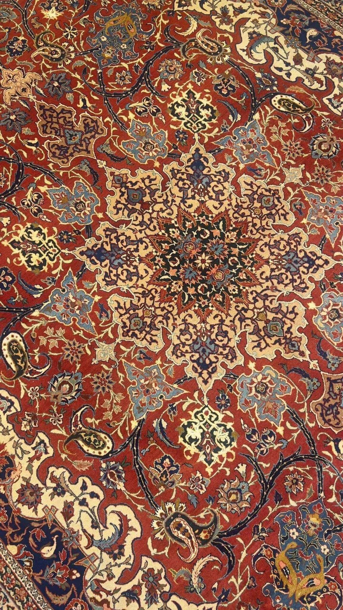 "Hand-knotted Isfahan rug with classic floral design in rich colors"
